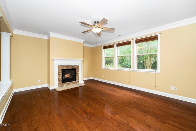 532 Front Ridge Dr, Cary, NC 27519 - unfurnished living room featuring decorative columns, a ceiling fan, dark wood-style floors, a stone fireplace, and crown molding