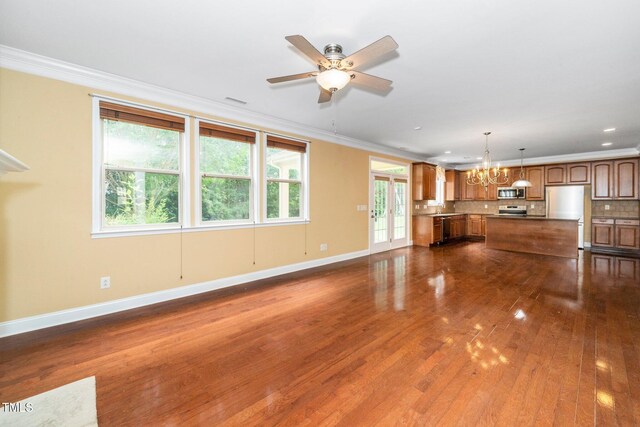 532 Front Ridge Dr, Cary, NC 27519 - unfurnished living room featuring a chandelier, baseboards, dark wood finished floors, ornamental molding, and healthy amount of natural light