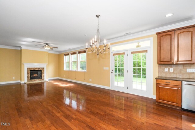 532 Front Ridge Dr, Cary, NC 27519 - unfurnished living room with dark wood finished floors, baseboards, crown molding, a stone fireplace, and ceiling fan