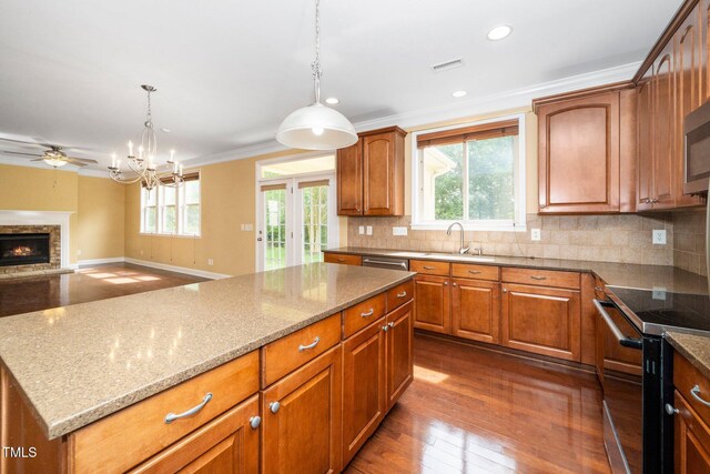 532 Front Ridge Dr, Cary, NC 27519 - kitchen with a sink, range with electric cooktop, plenty of natural light, light stone countertops, and ornamental molding