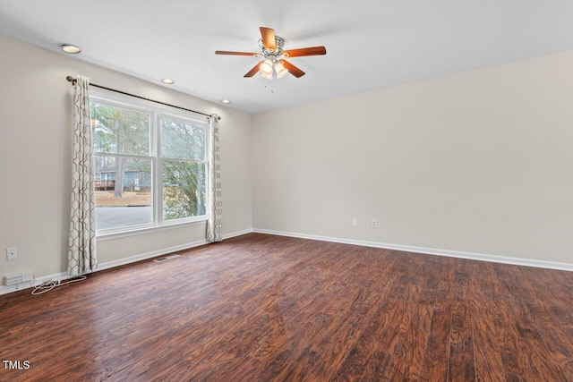 unfurnished room featuring a ceiling fan, visible vents, baseboards, and wood finished floors