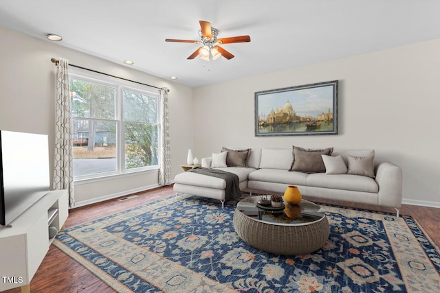 living room featuring a ceiling fan, baseboards, wood finished floors, and recessed lighting