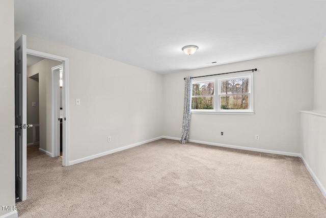 carpeted spare room with baseboards