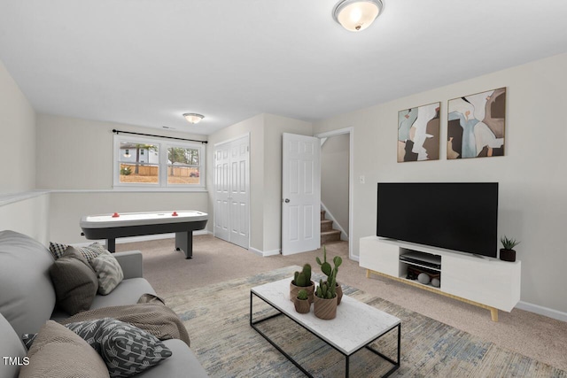 carpeted living area featuring baseboards