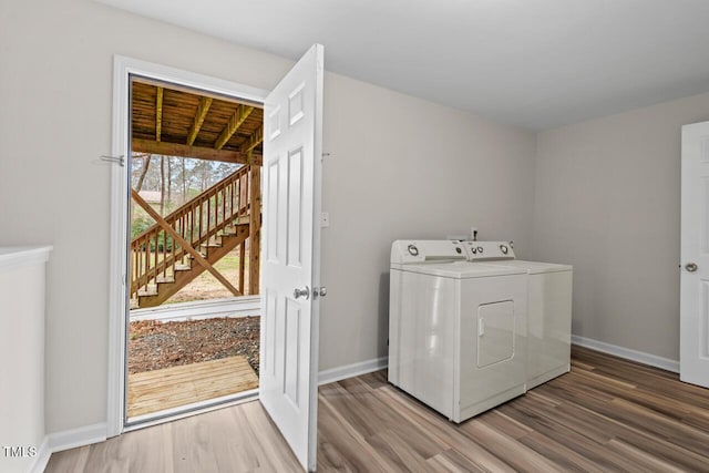 washroom with laundry area, independent washer and dryer, baseboards, and wood finished floors