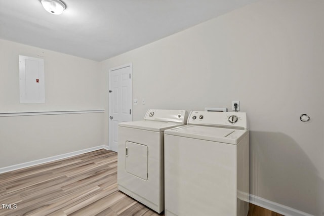 washroom with laundry area, electric panel, baseboards, and washing machine and clothes dryer