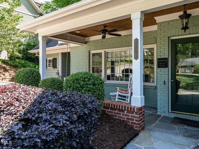 3504 Rock Creek Dr, Raleigh, NC 27609 - view of exterior entry with covered porch, ceiling fan, and brick siding
