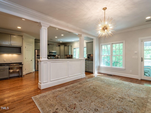 3504 Rock Creek Dr, Raleigh, NC 27609 - kitchen with gray cabinets, decorative columns, appliances with stainless steel finishes, and wood finished floors