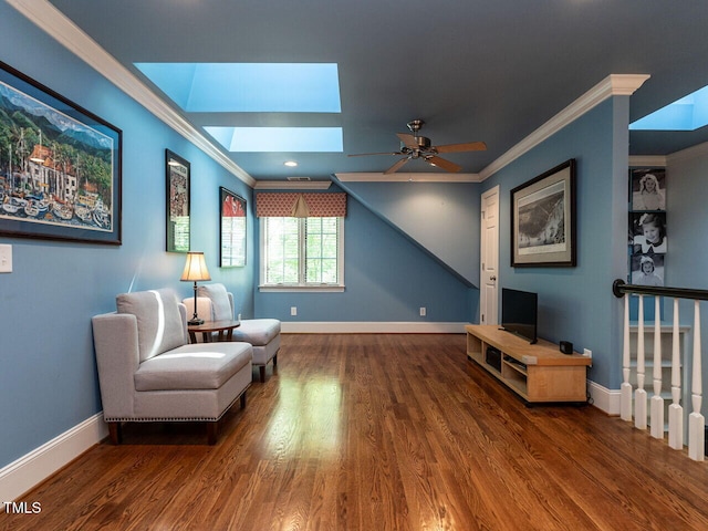 3504 Rock Creek Dr, Raleigh, NC 27609 - sitting room featuring crown molding, a ceiling fan, baseboards, wood finished floors, and a skylight
