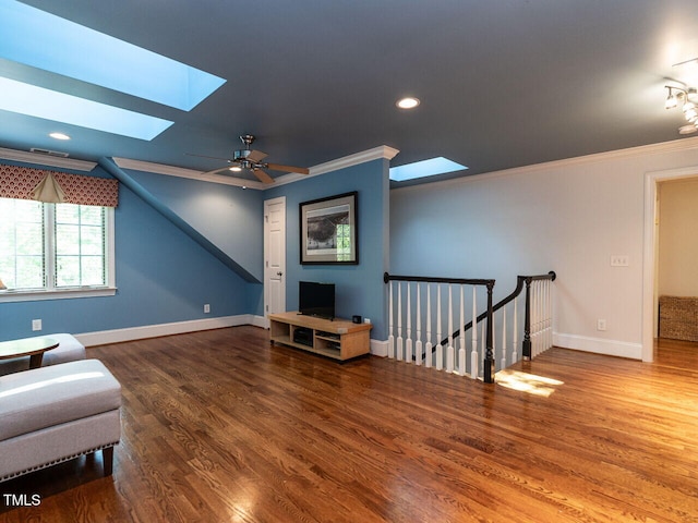 3504 Rock Creek Dr, Raleigh, NC 27609 - living area with a skylight, an upstairs landing, ornamental molding, and wood finished floors