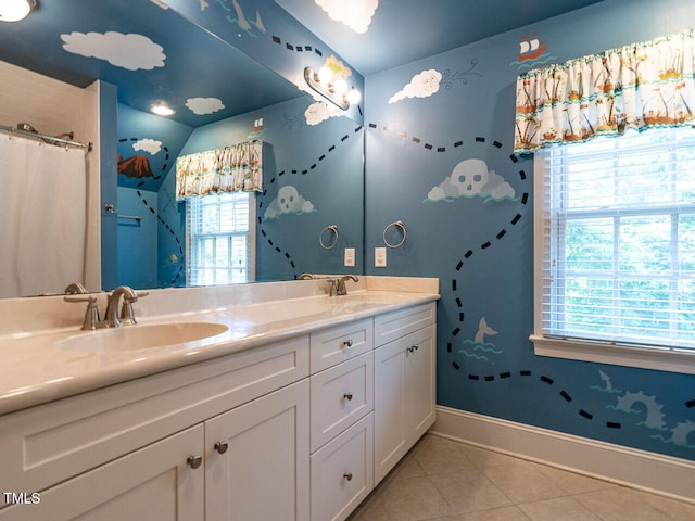 3504 Rock Creek Dr, Raleigh, NC 27609 - full bath with baseboards, double vanity, tile patterned floors, and a sink