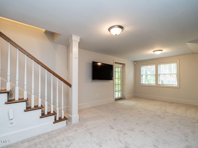 3504 Rock Creek Dr, Raleigh, NC 27609 - unfurnished living room with stairs, baseboards, and carpet