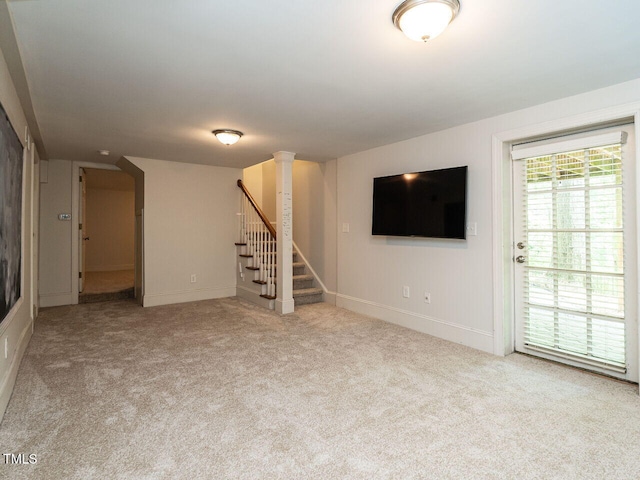 3504 Rock Creek Dr, Raleigh, NC 27609 - unfurnished living room featuring baseboards, carpet, and stairs