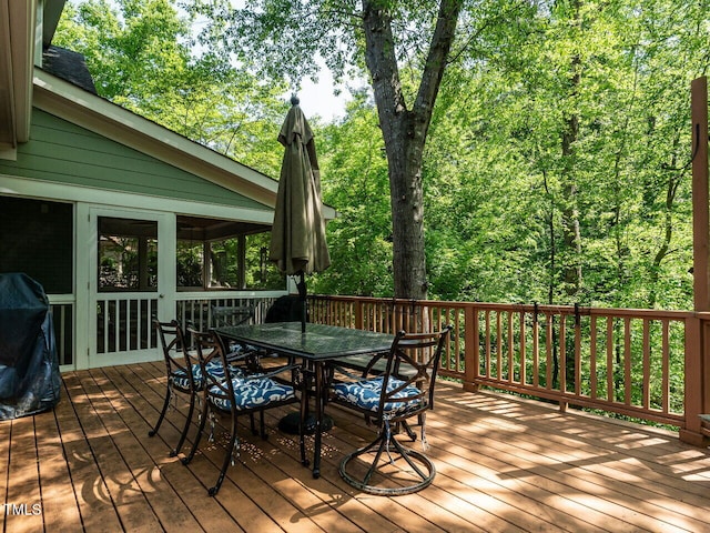 3504 Rock Creek Dr, Raleigh, NC 27609 - deck featuring outdoor dining area, a sunroom, and a wooded view