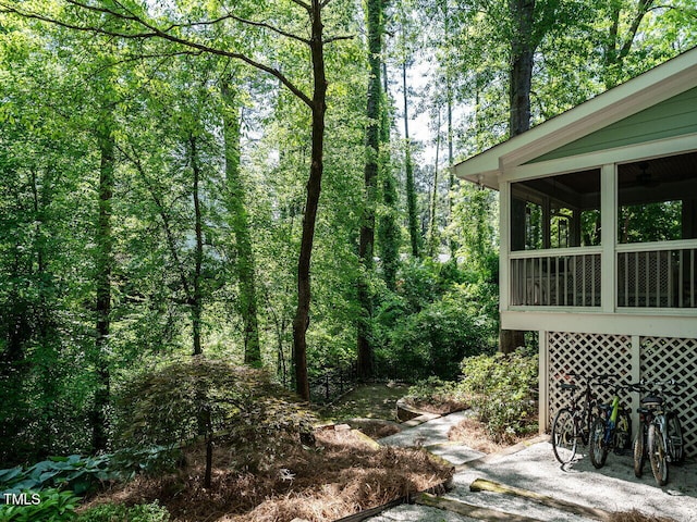 3504 Rock Creek Dr, Raleigh, NC 27609 - view of yard featuring a sunroom and a forest view