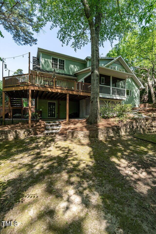 3504 Rock Creek Dr, Raleigh, NC 27609 - back of property with a wooden deck and a carport