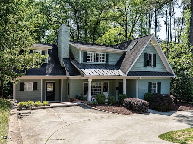 3504 Rock Creek Dr, Raleigh, NC 27609 - view of front facade with a porch, brick siding, and a standing seam roof