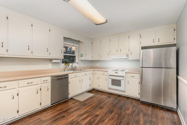 kitchen featuring appliances with stainless steel finishes, light countertops, a sink, white cabinetry, and under cabinet range hood