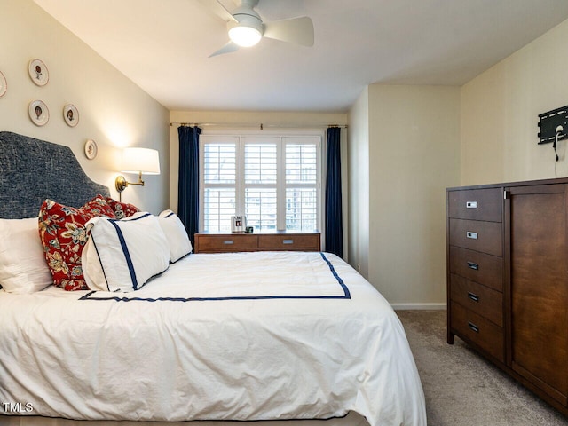 bedroom with ceiling fan, baseboards, and light colored carpet