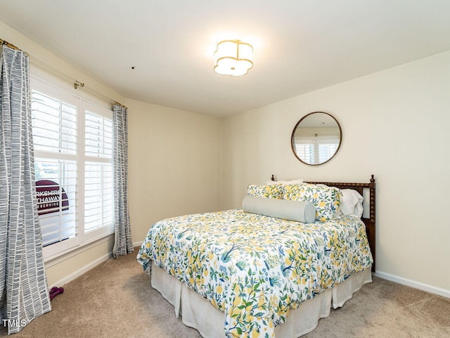 bedroom with carpet floors and baseboards