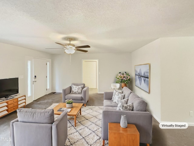 living room with ceiling fan, carpet floors, and a textured ceiling