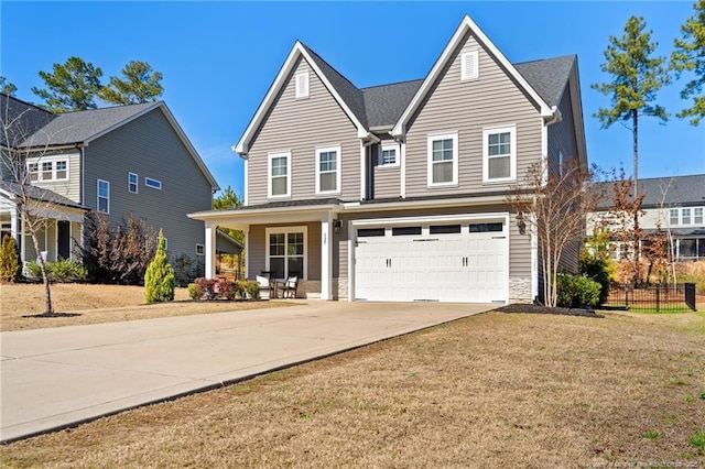 view of front facade featuring a garage, a front lawn, and covered porch