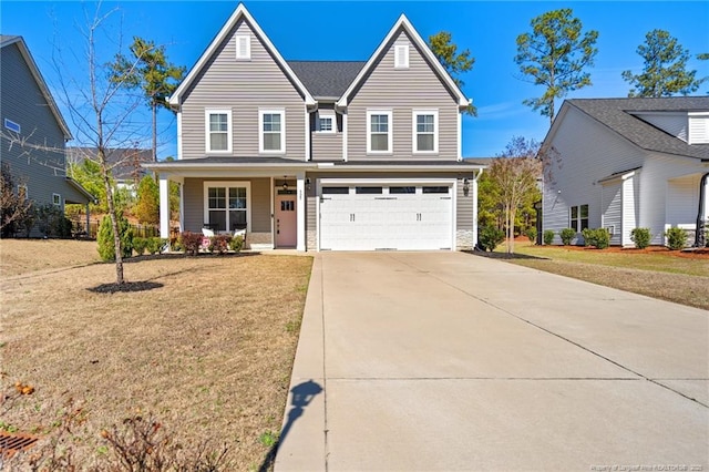 view of front property with a garage, a front lawn, and covered porch