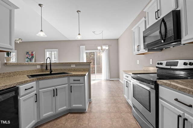 kitchen with hanging light fixtures, black appliances, gray cabinets, and a sink