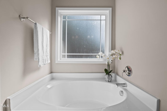 bathroom featuring a bath and a healthy amount of sunlight