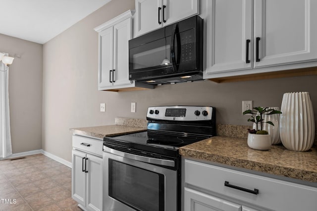 kitchen with black microwave, white cabinets, baseboards, and stainless steel electric range