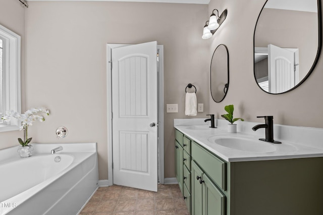 full bathroom featuring double vanity, a sink, a bath, and baseboards