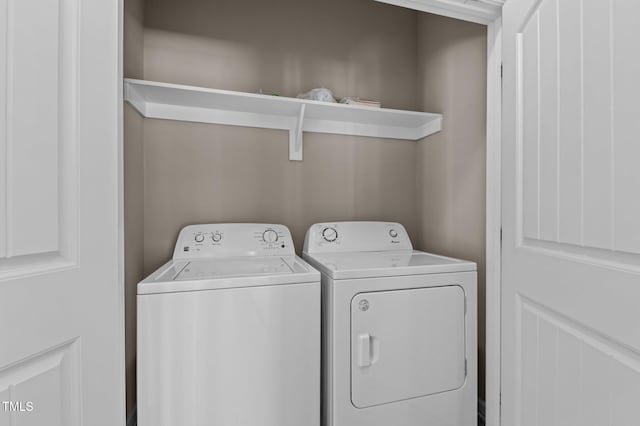 clothes washing area with laundry area and separate washer and dryer