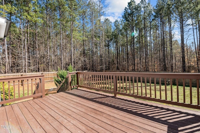 wooden terrace featuring a lawn