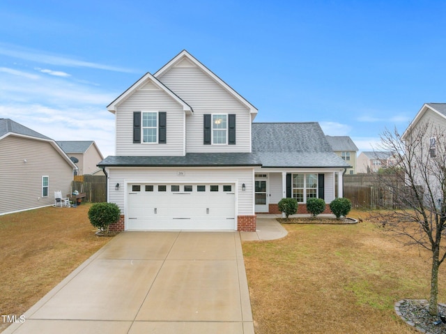 front of property with a garage, a front yard, and covered porch