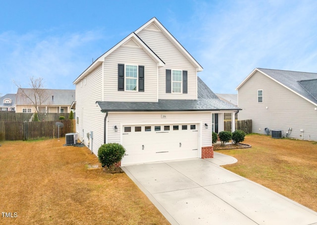 view of property featuring a garage, a front lawn, and central air condition unit