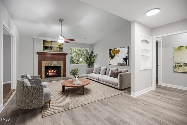 1512 Maybrook Dr, Raleigh, NC 27610 - living room with a tiled fireplace, wood finished floors, baseboards, and a ceiling fan