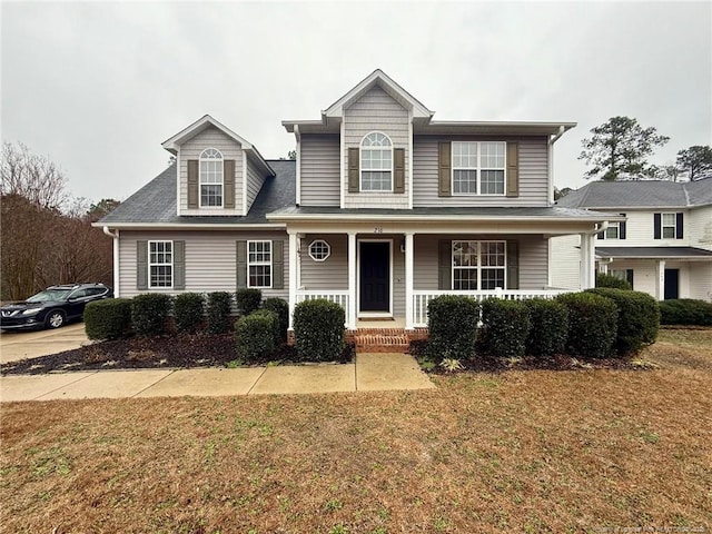 view of property with a front yard and a porch