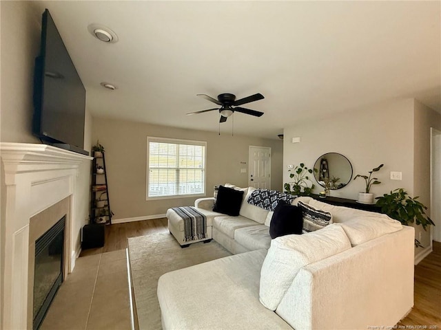 living room featuring wood-type flooring and ceiling fan