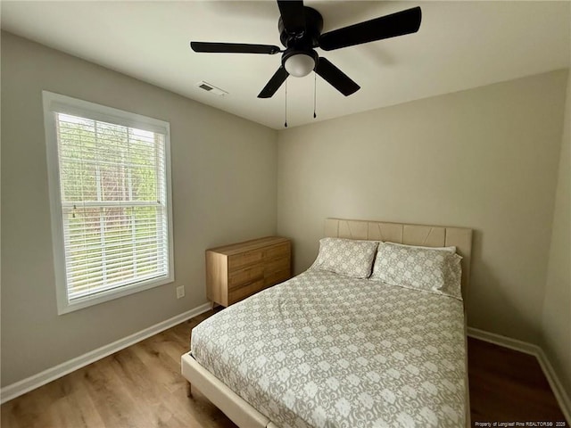 bedroom with wood-type flooring and ceiling fan