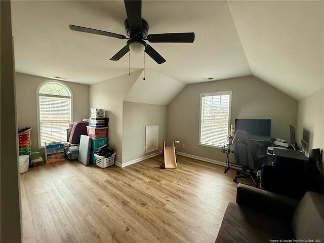 additional living space with ceiling fan, lofted ceiling, and light wood-type flooring