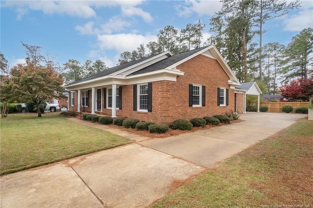 view of side of property with a yard and covered porch