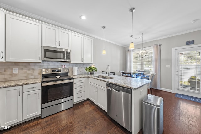 kitchen featuring tasteful backsplash, appliances with stainless steel finishes, a sink, and crown molding