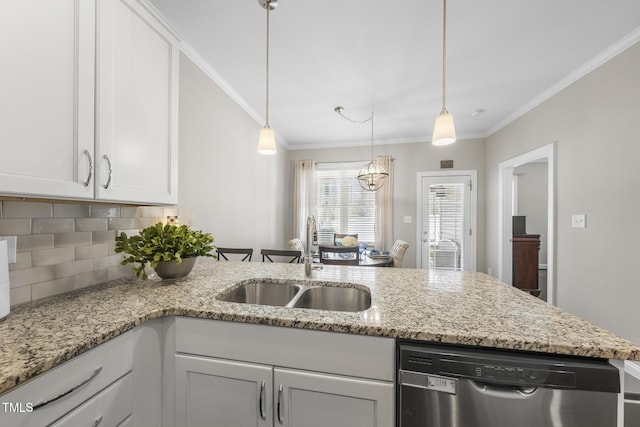 kitchen featuring a peninsula, stainless steel dishwasher, ornamental molding, and a sink