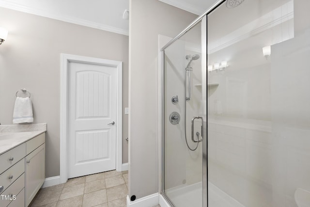 bathroom featuring a stall shower, tile patterned flooring, crown molding, and vanity