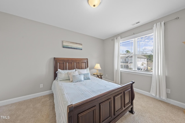 bedroom with light colored carpet, visible vents, and baseboards