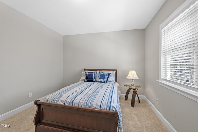 bedroom featuring carpet and baseboards