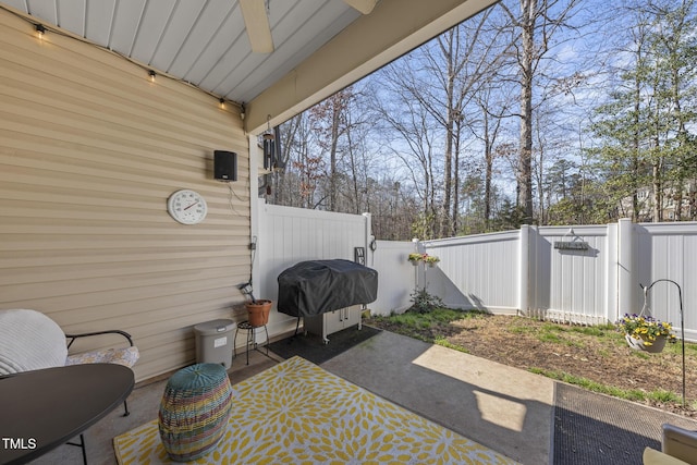 view of patio / terrace with a grill and fence