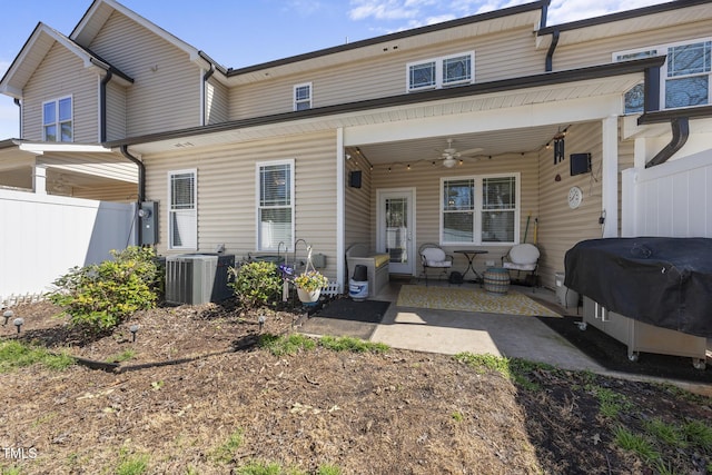 rear view of property featuring central AC unit, ceiling fan, fence, and a patio