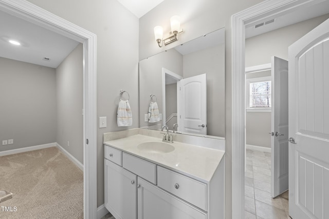 bathroom with tile patterned floors, baseboards, visible vents, and vanity