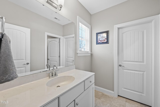 bathroom with tile patterned flooring, vanity, visible vents, and baseboards